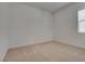Empty bedroom featuring neutral carpet and a bright window with neutral paint at 827 Klamath Springs St, Henderson, NV 89011