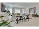 A sunlit living room features neutral furnishings, decor, and white tile floors at 827 Klamath Springs St, Henderson, NV 89011