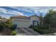 Front exterior showing a well maintained single-story home with beautiful desert landscaping at 8277 Orange Vale Ave, Las Vegas, NV 89131