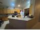 Another angle of kitchen with ample counter space, light wood cabinets, and stainless appliances at 8277 Orange Vale Ave, Las Vegas, NV 89131