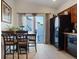 Bright eat-in kitchen with tiled floors and a sliding glass door to the backyard at 8550 Little Fox St, Las Vegas, NV 89123