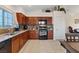 Well-lit kitchen boasts dark wood cabinetry, a breakfast bar and stainless appliances at 8550 Little Fox St, Las Vegas, NV 89123