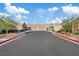 A tidy street view showcases garages and manicured landscaping under a blue sky at 8550 Little Fox St, Las Vegas, NV 89123