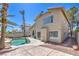 Exterior of two-story home with a private pool, rock waterfall, and well-manicured landscaping at 8712 Texas Bronco Ave, Las Vegas, NV 89129
