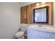 Stylish half bathroom with a unique wood accent wall and a modern vanity at 8712 Texas Bronco Ave, Las Vegas, NV 89129