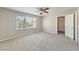 Carpeted bedroom with a ceiling fan, natural light, and a walk-in closet at 8712 Texas Bronco Ave, Las Vegas, NV 89129