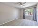 Bright bedroom with a ceiling fan, window and comfortable carpet at 8712 Texas Bronco Ave, Las Vegas, NV 89129