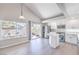 Modern kitchen with stainless steel appliances, white cabinets, a center island, and easy access to the backyard at 8712 Texas Bronco Ave, Las Vegas, NV 89129