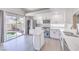 Modern kitchen with white cabinets, stainless steel appliances, and a view of the pool at 8712 Texas Bronco Ave, Las Vegas, NV 89129
