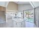 Stylish kitchen with white countertops overlooking an outdoor pool area and stairs to second floor at 8712 Texas Bronco Ave, Las Vegas, NV 89129
