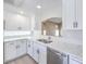 Well-lit kitchen showcasing stainless steel appliances, pristine white cabinets, and elegant marble countertops at 8712 Texas Bronco Ave, Las Vegas, NV 89129
