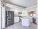 Updated kitchen features stainless steel appliances, white cabinets, quartz countertops, and backyard access at 8712 Texas Bronco Ave, Las Vegas, NV 89129