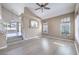 Spacious living room with hardwood floors, a ceiling fan, and lots of natural light at 8712 Texas Bronco Ave, Las Vegas, NV 89129
