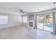 Bright living room with a fireplace, sliding glass doors to pool, and modern finishes, providing relaxed indoor/outdoor living at 8712 Texas Bronco Ave, Las Vegas, NV 89129