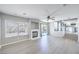 Spacious living room with a cozy fireplace, large windows, and an open floor plan, perfect for entertaining at 8712 Texas Bronco Ave, Las Vegas, NV 89129