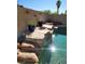 Backyard pool featuring a stone waterfall, desert landscaping and hardscape at 8712 Texas Bronco Ave, Las Vegas, NV 89129