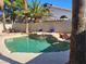 Backyard pool with stone waterfall feature, palm trees, and rock landscaping creates a desert oasis at 8712 Texas Bronco Ave, Las Vegas, NV 89129