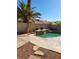 Backyard pool featuring a rock waterfall and mature landscaping, perfect for outdoor relaxation at 8712 Texas Bronco Ave, Las Vegas, NV 89129