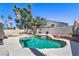 Inviting backyard pool area with mature palm trees and a custom rock waterfall feature at 8712 Texas Bronco Ave, Las Vegas, NV 89129
