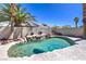 Backyard oasis with a custom pool, rock waterfall feature, and lush palm trees at 8712 Texas Bronco Ave, Las Vegas, NV 89129