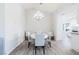 Bright dining room featuring a modern chandelier, white table, and stylish upholstered chairs at 8812 Marble Dr, Las Vegas, NV 89134
