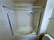 Enclosed white bathtub and shower with safety bar and handheld shower faucet at 9070 Spring Mountain Rd # 109, Las Vegas, NV 89117