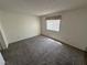 Carpeted bedroom with natural light from the window, creating a tranquil atmosphere at 9070 Spring Mountain Rd # 109, Las Vegas, NV 89117
