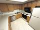 Well-lit kitchen featuring essential appliances, light wood cabinets, and ample counter space at 9070 Spring Mountain Rd # 109, Las Vegas, NV 89117