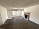 Spacious carpeted living room with a decorative fireplace, offering a comfortable space to relax at 9070 Spring Mountain Rd # 109, Las Vegas, NV 89117