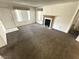 Spacious carpeted living room with a fireplace and access to a door at 9070 Spring Mountain Rd # 109, Las Vegas, NV 89117