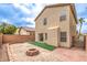 Spacious backyard featuring low-maintenance landscaping, brick walls, and a cozy fire pit at 9129 Patrick Henry Ave, Las Vegas, NV 89149