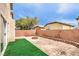 Backyard features an in-ground fire pit and artificial turf and a brick perimeter at 9129 Patrick Henry Ave, Las Vegas, NV 89149
