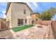Large backyard featuring low-maintenance landscaping, privacy walls, and an in-ground fire pit at 9129 Patrick Henry Ave, Las Vegas, NV 89149