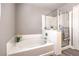 This bathroom features a tub, shower and neutral paint to create a peaceful retreat at 9129 Patrick Henry Ave, Las Vegas, NV 89149