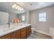 This bathroom features a double sink vanity with plenty of storage and is well-lit with a large mirror and natural light at 9129 Patrick Henry Ave, Las Vegas, NV 89149