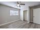 Cozy bedroom with wood-look floors, closet, window and ceiling fan with lighting at 9129 Patrick Henry Ave, Las Vegas, NV 89149