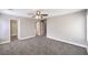 Spacious bedroom with neutral paint, plush carpet, a ceiling fan, walk-in closet and access to other rooms in the home at 9129 Patrick Henry Ave, Las Vegas, NV 89149