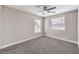 This bedroom features neutral walls, carpet, a ceiling fan and a window with wood blinds at 9129 Patrick Henry Ave, Las Vegas, NV 89149