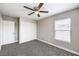 This bedroom has gray carpet, neutral walls, a window with wood blinds and a closet at 9129 Patrick Henry Ave, Las Vegas, NV 89149