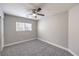 This bedroom features neutral paint, plush carpeting and ample natural light from the window and a ceiling fan at 9129 Patrick Henry Ave, Las Vegas, NV 89149