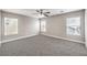 This spacious bedroom features neutral paint, plush carpeting, and ample natural light from the multiple windows at 9129 Patrick Henry Ave, Las Vegas, NV 89149