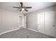 This bedroom features neutral paint, plush carpeting and a ceiling fan for comfort, with ample storage in the closet at 9129 Patrick Henry Ave, Las Vegas, NV 89149