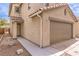 Home featuring a two-car garage, desert landscaping, and a well-defined walkway at 9129 Patrick Henry Ave, Las Vegas, NV 89149