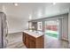 Kitchen island with quartz countertop, stainless steel refrigerator, and backyard access at 9129 Patrick Henry Ave, Las Vegas, NV 89149