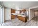 Well-lit kitchen with wood floors, stainless steel appliances, and a kitchen island at 9129 Patrick Henry Ave, Las Vegas, NV 89149