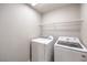 This laundry room features a Samsung washer and dryer and a shelf for storage at 9129 Patrick Henry Ave, Las Vegas, NV 89149