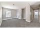Large living room featuring neutral carpet, a window and hallway access at 9129 Patrick Henry Ave, Las Vegas, NV 89149