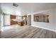 Open-concept living room featuring wood floors, a kitchen island, and stainless steel appliances at 9129 Patrick Henry Ave, Las Vegas, NV 89149