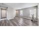 An airy, neutrally decorated living room featuring stylish laminate flooring and three windows at 9129 Patrick Henry Ave, Las Vegas, NV 89149