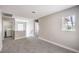 This cozy loft features neutral paint, plush carpeting, and natural light from the window, offering a versatile space at 9129 Patrick Henry Ave, Las Vegas, NV 89149